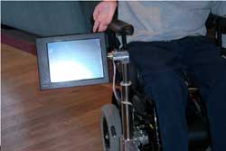 Photos 1 - 4 demonstrate movement of mount, from resting position alongside chair to final destination in front of user. 