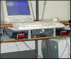 Photo 1 shows the Force Sensitive Platform, which consists of two Omega load cells, positioned between two aluminum plates with Sensotec signal conditioner indicators (amplifier) on each side of the load cell. 