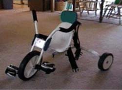 Photograph shows the original tricycle design with extended handlebars and traditional pedaling system. 
