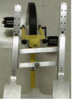 The steering system is composed of four bars. Two parallel vertical bars are connected to shoulder pads, which allow the user to steer. Two horizontal bars are connected also in parallel to the vertical bars, so that they will always remain in the same plane. The front horizontal bar is directly connected to the wheel while the other horizontal bar is connected to the tricycle base to ensure that the steering system is secure. 