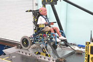 Figure 1.  Pre-test photo of first prototype.  The figure shown a front oblique view of a three-year-old sized ATD secured by a five-point harness to a pediatric wheelchair.
