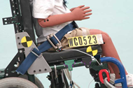 Figure 3.  Side view of second wheelchair prototype showing stronger bracket between seatback post and seat rail with slot for anchoring lap belt using three-bar clip.