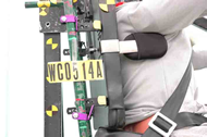 This figure shows the right-side seatback detachments that resulted from the test of planar seat B installed on the SWCB.  The detachments are identical to those shown in Figure 3 with the top and bottom seatback hooks sliding out of their respective retaining brackets and detaching from the seatback post.  