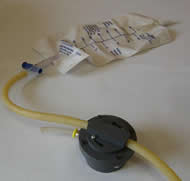 Figure 1 shows the “Bonnet Style” valve connected to a leg bag and drain tube as it would be during use.  The sipping tube would be long enough to reach the user’s mouth conveniently.  The twist on cover holds the drain tube in place for compression when not being drained.