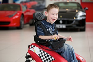 Picture of toddler in Wizzybug pediatric mobility device