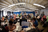 TechShop space showing multiple teams working on computer and other equipment