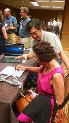 Developer demonstrating assistive writing device 