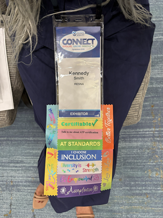 Conference badge with a long line of funny ribbons attached. 