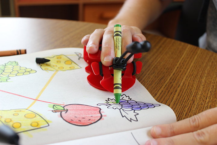 Showing how it works holding a crayon and coloring