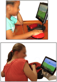 Picture of children interacting with a tablet using a switch. There are two images. The top image shows a young boy interacting with the tablet using TabAccess, a Bluetooth switch interface. The bottom image shows a young girl interacting with the tablet using a Bluetooth plush switch.   