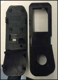 Figures 3 and 4: Both the images on the right and left show a top and bottom view of the Fused Deposition Modeling (FDM) 3D printed CAD models of housing. The top of the black housing has 3 walls and contains openings for the joystick, mode select switch, potentiometer, LCD screen, and connecting bolts.  The black bottom plate has a top half that is angled at 30 degrees and contains fixturing mechanisms for the nuts and bolts as well as holes for the attached wires. 