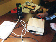 An early prototype of a charging base for a hands-free electric wheelchair charger.