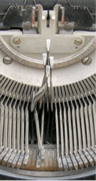 The letter arms of a mechanical typewriter are shown tangled so that they cannot return to their rest state, and new letters cannot be typed.