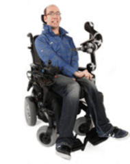 A picture of a user in a power wheelchair equipped with a JACO robot.