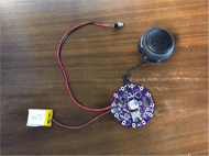 The current prototype of the switch-activated MP3 player consists of a circular printed circuit board (which contains the SD card reader and the microprocessor), a battery, a switch jack and a speaker.