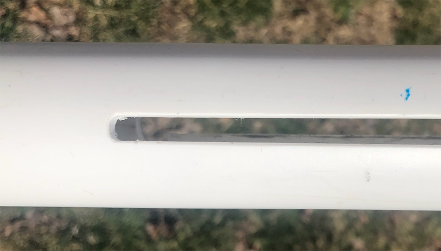  White PVC pipe with slot cut out to show where the PVC pipe is closed at one end.