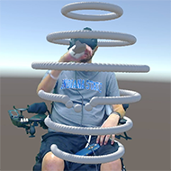 A wheelchair user in mixed reality VR pushing away rings of virtual spheres that encircle his body at different heights from head level to below the waist.