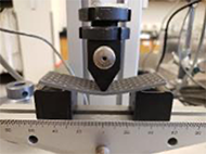 The Unidirectional 3-Point Bend sample is being compressed by the force applicator during the 3-Point Bend Test.