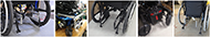 Figure 3 is a compilation of 5 photos of the rear lower portion of commercial wheelchairs with the UDIG hardware added.  In each photo, two vertical bars have been added to the structure of the wheelchair inside of the rear wheels and well above the lowest portion of the wheelchair frame. From left to right, hardware designed for KiMobility Catalyst 5, Quantum Q6 Edge 2, Sunrise Quickie 2, a Permobil F3 Corpus, and a Motion Concepts Helios wheelchair.