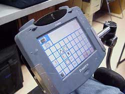 This is a photograph of the screen of a DynaMyte 3100 set up for game play with touch screen via head pointer for access. 
