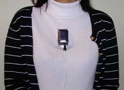 This photo shows the position of the MT9 motion sensor below the collar bones on the front torso of a subject. It is the size of a D cell battery. 