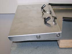 Image shows the top view of the 9 x 6 envelope inserting aid. The 12 x 8.5 envelope aluminum tray has two angled edges to align documents. The channel defines a trapezoidal opening.