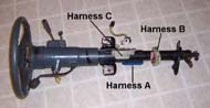 This photo shows the steering column with three wiring harnesses identified for interface to the software simulator.