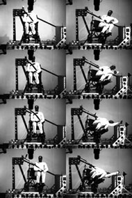 Figure 3:  Figure three shows eight photos taken 15 milliseconds apart during test A that show an overview of the wheelchair and dummy movements during the test.  In test A the wheelchair frame moves between nine and ten inches laterally and the ATD bends toward the left from the waist contacts the armrest and reaches a maximum dynamic torso angle of over ninety degrees.