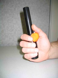 .  The handle itself is a piece of delrin that is slightly curved at the grip and a hollow cylinder to the top that holds the electronics. This photo shows a handle, fabricated out of delrin, and an electronic switch attached to the side with a ball of formed play dough.
