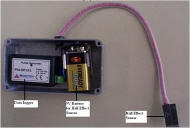 (Wheelchair Monitoring System) This picture shows the Wheelchair Monitoring System.  The datalogger and a 9V battery are enclosed a metal box with wires leading out of the box to the Hall Effect sensor.