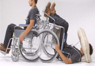 There are two pictures within the picture of a person demonstrating the activation of the “Pop” system during a backward fall. First picture user sits upright in the wheelchair and second pictures user lies backward on the floor with head protected by inflated airbag. 