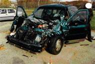 Photo of damaged 1996 Ford Windstar in case WC-014 showing damage that extends over the entire front end and above the bumper to the base of the windshield.