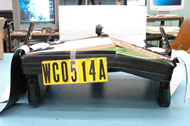 This figure shows a complete fracture of the seatpan of planar seat B after tesing on the SWCB.  The fracture is slightly to the left of the centerline and penetrates all layers of plywood as it extends down the length of the seatpan.