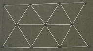 The figure shows a carpet instrumented with RFID tags. This RFID carpet is placed at strategic locations in teh store, and used by RoboCart to localize. The RFID tags are placed in the carpet in a hexagonal pattern. Distance between any two tags is 15 cm.