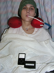 This picture shows a Shepherd Center patient using the ipod sip & puff unit.