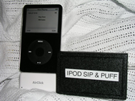 This picture is a close-up of the sip & puff unit as its box sits beside the patient’s ipod.