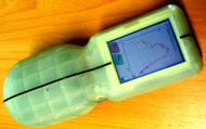 This figure shows a close-up photograph the hand-held dynamometer with a typical recording of strength against range of motion for an elbow joint.  