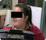 This photograph shows a video close up of an expert user’s face with embedded video in the upper left hand corner of the robot she is looking at.