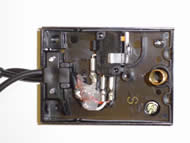 Image shows the overhead view of the SPDT pedal with cover removed. External cables lead into the pedal and connect to an SPDT switch with three connection ports. A spring located at the pedal base returns the pedal to its original position.