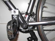 This photo of the final device shows how the crank arm sections overlap each other to change the pedal motion.  The pedal section overlaps the upper section maximally at the peak of the pedal rotation, and it does not overlap at the bottom of the pedal motion. 