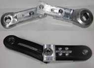 This picture shows the adjustable-length crank arm (top) and the final design.  The prototype uses two aluminum fasteners, while the final device only uses one, which attaches to the inside section of the crank arm.  Only prototype 2 has slots in the fasteners for adjustability.  This adjustability was used to determine the relative crank arm lengths implemented in the final design.  Based on the client’s maximum flexion with the adjustable-length crank arm, the outer and inner sections of the final design are 78 mm and 127 mm long. 