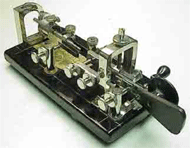 The Morse code bug has a "paddle" which is pressed one direction to produce a "dit" and the opposite direction to produce a "dah".